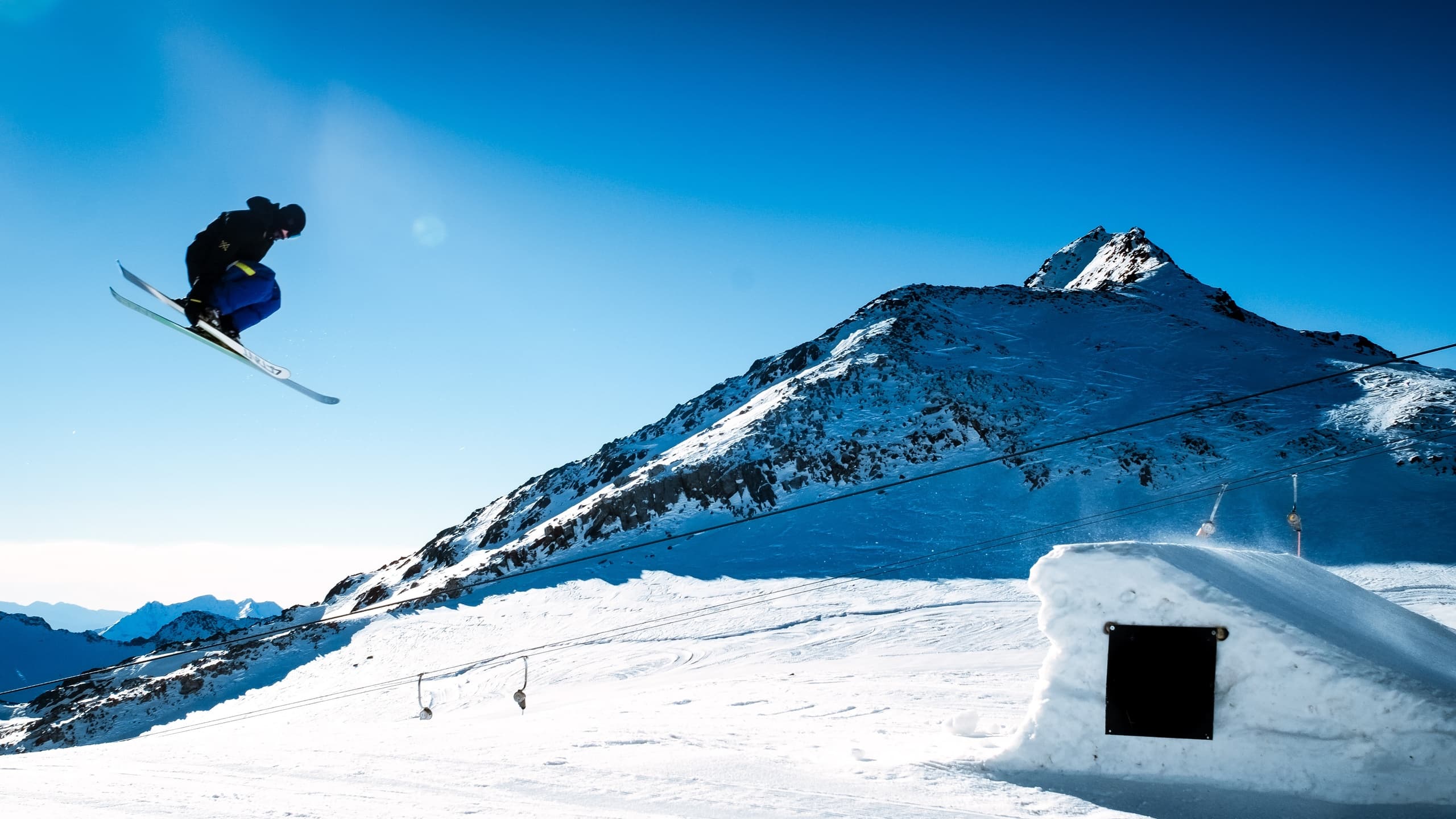 Man jumping over hurdle while skiing