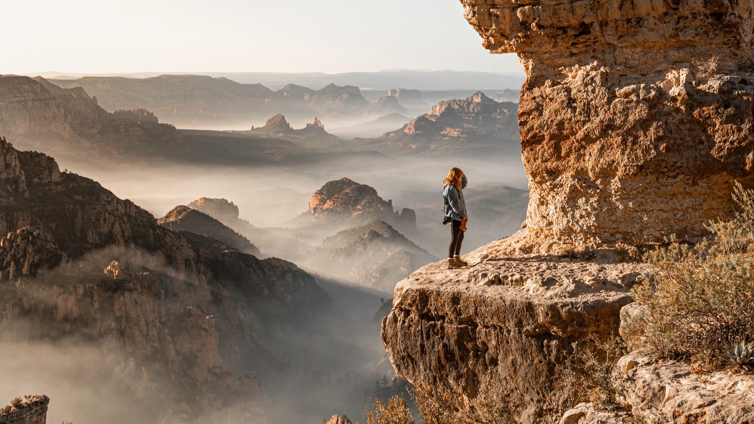 Woman on mountaintop staring into distance