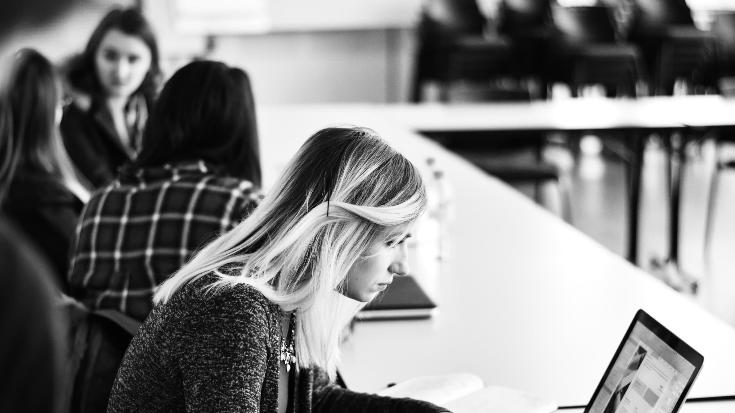 Woman staring at laptop.