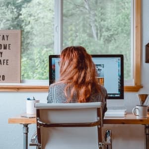 Woman working at computer in home office